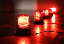 Drone Massacres Schoolgirls — 17 Dead Red emergency lights on dark floor, illuminating the area.