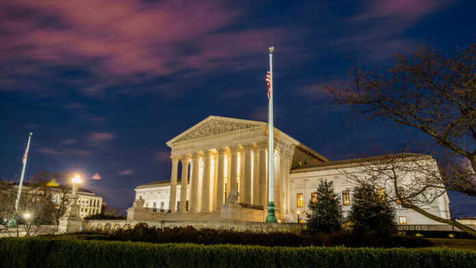 The United States Supreme Court building at dusk.