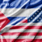 Close-up of the Cuban and American flags displayed together