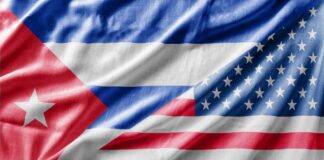 Close-up of the Cuban and American flags displayed together