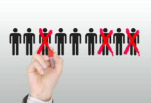 20% Layoff Bombshell Hits Social Media Giant Hand crossing out stick figures with a red marker.