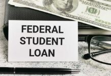 A sign reading 'Federal Student Loan' next to a stack of money and a pen