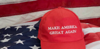Red Make America Great Again hat on American flag