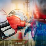 Gas pump with financial data overlay and oil refinery in the background