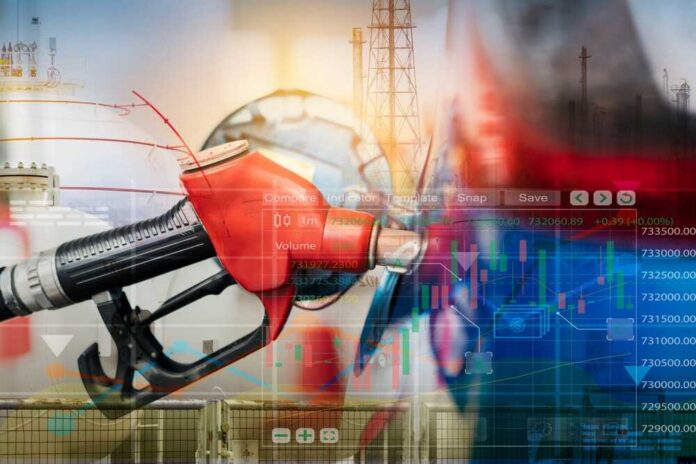 Gas pump with financial data overlay and oil refinery in the background