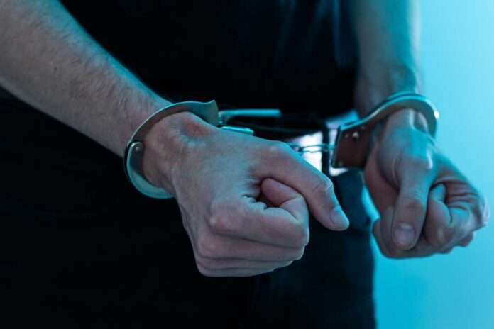 shutterstock_2345979201.jpg Close-up of hands in handcuffs