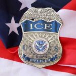 ICE officer badge placed on an American flag
