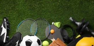 Variety of sports equipment arranged on green grass