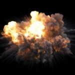 A large explosion with flames and smoke against a black background