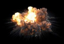 A large explosion with flames and smoke against a black background