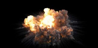 A large explosion with flames and smoke against a black background