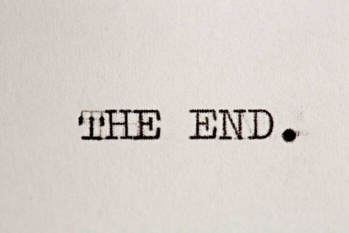 Typewritten text reading 'THE END.' on a sheet of paper