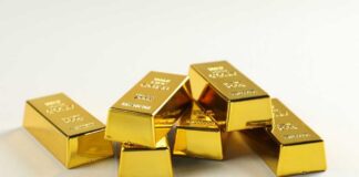 A stack of shiny gold bars arranged on a light background