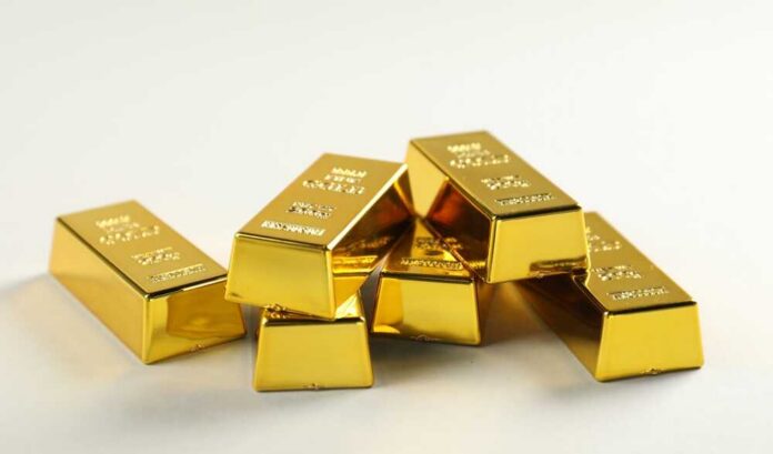 A stack of shiny gold bars arranged on a light background