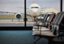 View of an airplane from an airport waiting area