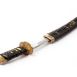 A traditional Japanese katana with a black wrapped handle and a shiny blade