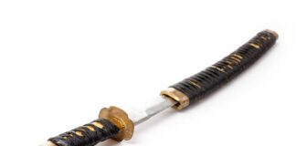 A traditional Japanese katana with a black wrapped handle and a shiny blade