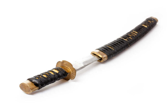 A traditional Japanese katana with a black wrapped handle and a shiny blade