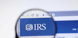 Magnifying glass focusing on IRS website logo.