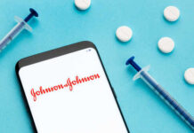 Smartphone displaying Johnson & Johnson logo with syringes and pills