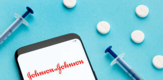 Smartphone displaying Johnson & Johnson logo with syringes and pills