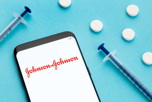 Smartphone displaying Johnson & Johnson logo with syringes and pills