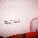 Close-up of a typewriter with the word 'JOBLESS' typed on paper