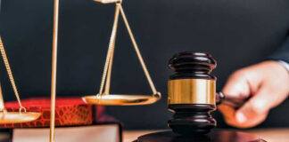 Judge gavel, scales of justice, and law books.