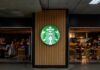 Starbucks coffee shop entrance with logo and customers inside