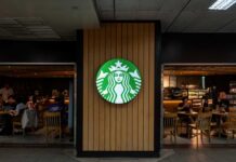 Starbucks coffee shop entrance with logo and customers inside
