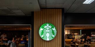 Starbucks coffee shop entrance with logo and customers inside