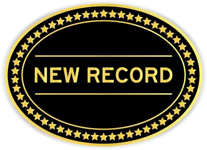 A badge displaying the text 'NEW RECORD' surrounded by gold stars