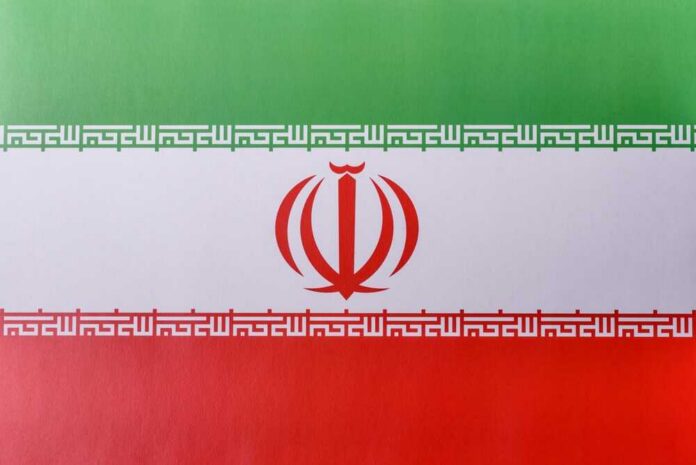 The flag of Iran featuring green, white, and red horizontal stripes with a central emblem