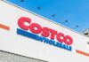 Costco Wholesale store sign against a blue sky