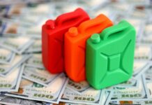 Gas Price Shock Threatens 2027 COLA For Seniors Three colorful plastic containers on a background of hundred dollar bills