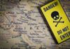 Iran’s New Target — Thousands at Risk A danger sign placed over a map of the Middle East