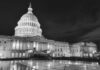 The U.S. Capitol building illuminated at night in black and white
