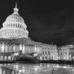 The U.S. Capitol building illuminated at night in black and white