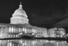 The U.S. Capitol building illuminated at night in black and white