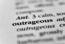 Massive Trump Monument Sparks Outrage Close-up of a dictionary entry highlighting the word 'outrageous'