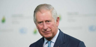 Man in suit with a blue tie.
