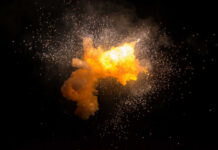 Bright explosion against a dark background with sparks.