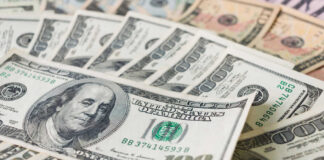 Stacks of various U.S. dollar bills.
