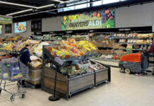 People shopping and cleaning inside an Aldi supermarket.