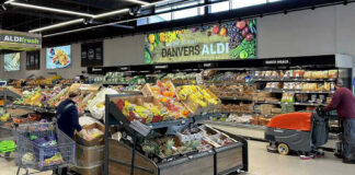 People shopping and cleaning inside an Aldi supermarket.