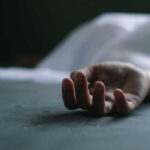 Six Bodies Found Sealed in Boxcar Dead persons hand lying on a gray surface
