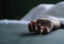 Six Bodies Found Sealed in Boxcar Dead persons hand lying on a gray surface