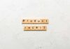 Wooden letter tiles spelling 'Product recall' on a textured surface