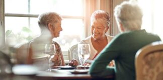 Group of senior women enjoying a meal and conversation at a table