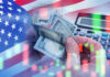 Billionaire’s Tax Plan SPARKS DEBATE – Could THIS Happen? USA flag calculator and hands holding dollars overlapping
